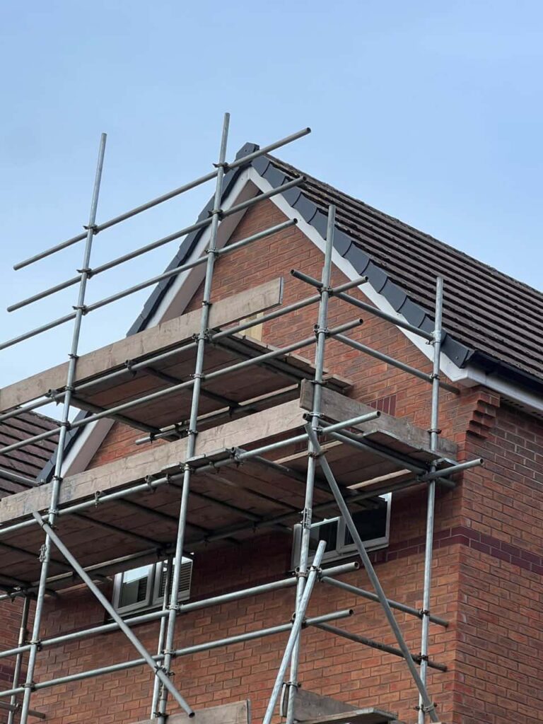 This is a photo of a roof which has just been repaired. There is a scaffold located at the gable end for access onto the roof. Works carried out by Warlingham Roofing Repairs